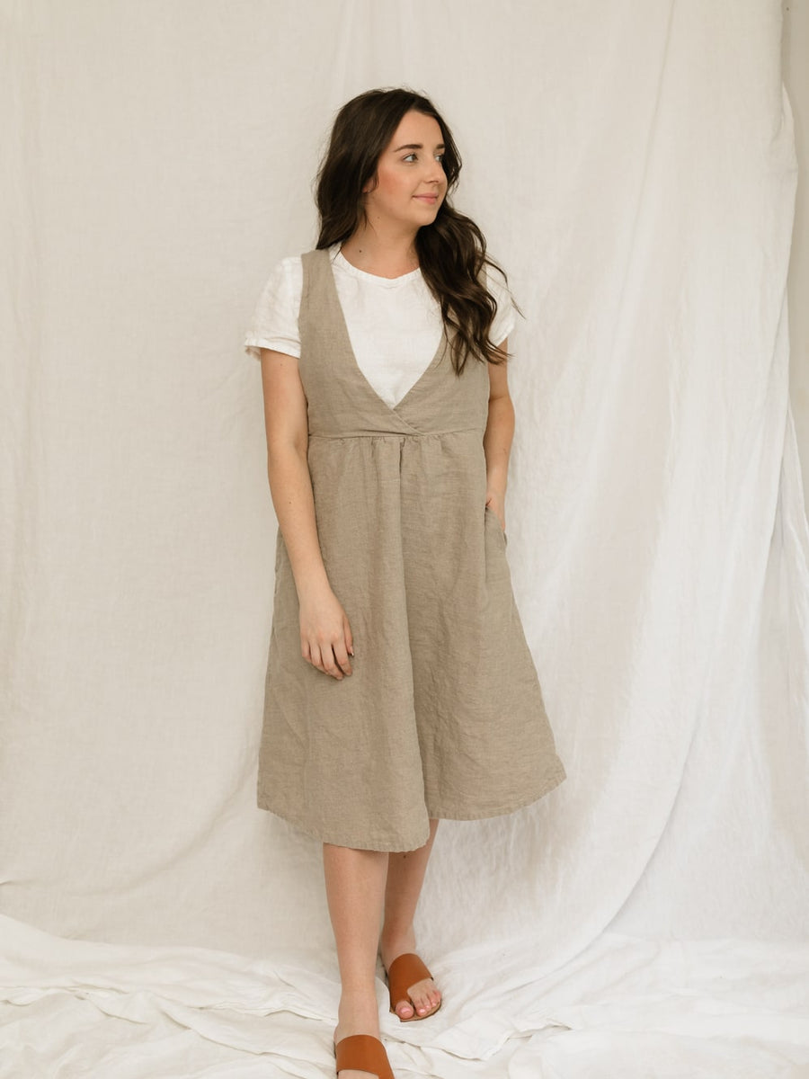 The Asa jumper features a crossed front bodice and plain back. The top of the dress is doubled for a clean finish and added durability. The gathered skirt includes hidden side seam pockets.  Perfect for the sustainable closet. Made with quality linen. Customizable sizes. 