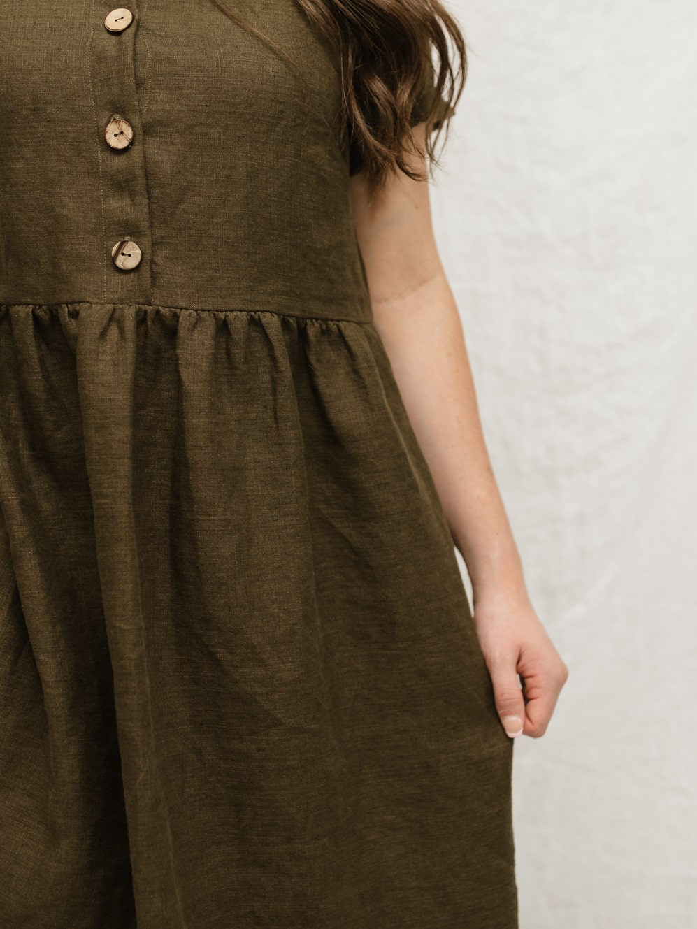 A handmade linen dress with gathered waist, buttons, and pockets. Perfect for the sustainable closet. Make with high quality, linen fabric and sizes can be customized.