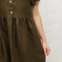 A handmade linen dress with gathered waist, buttons, and pockets. Perfect for the sustainable closet. Make with high quality, linen fabric and sizes can be customized.