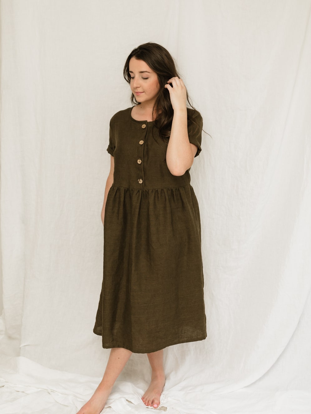 A handmade linen dress with gathered waist, buttons, and pockets. Perfect for the sustainable closet. Make with high quality, linen fabric and sizes can be customized.