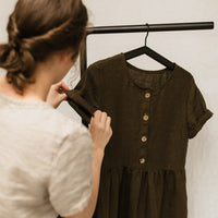 A handmade linen dress with gathered waist, buttons, and pockets. Perfect for the sustainable closet. Make with high quality, linen fabric and sizes can be customized.