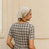 The Aaro smock is a handmade linen dress featuring a more structured bodice, including a set in sleeve and side bust darts, with an easy flowing skirt. The gathered waist skirt includes hidden side seam pockets.