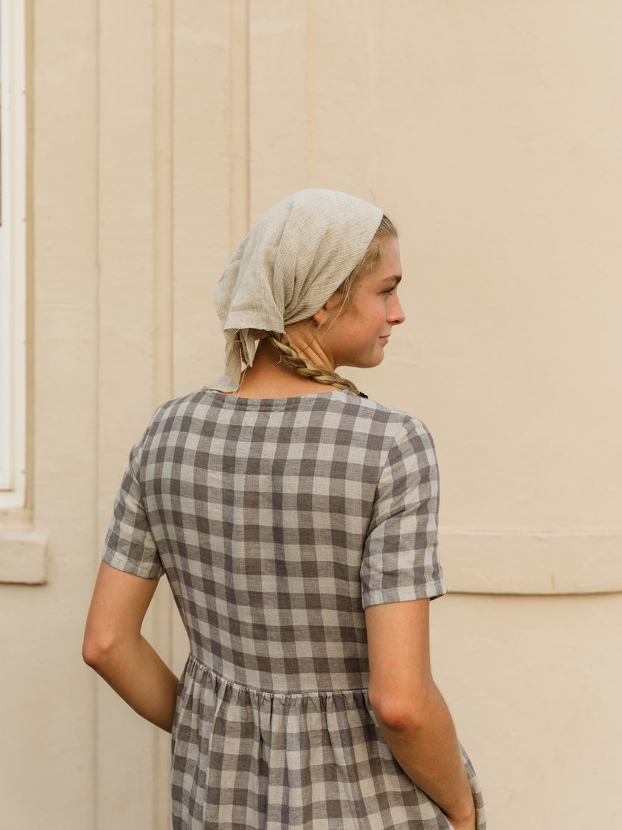 The Aaro smock is a handmade linen dress featuring a more structured bodice, including a set in sleeve and side bust darts, with an easy flowing skirt. The gathered waist skirt includes hidden side seam pockets.