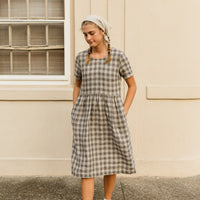 The Aaro smock is a handmade linen dress featuring a more structured bodice, including a set in sleeve and side bust darts, with an easy flowing skirt. The gathered waist skirt includes hidden side seam pockets.