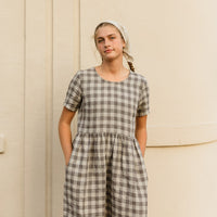 The Aaro smock is a handmade linen dress featuring a more structured bodice, including a set in sleeve and side bust darts, with an easy flowing skirt. The gathered waist skirt includes hidden side seam pockets.